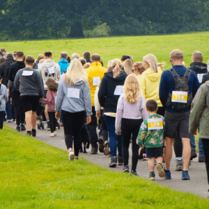 A group of people walking through a country park