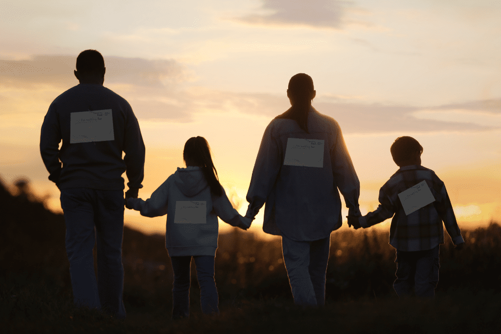 A family walk into the sunset with name plates on their back with who they're walking for